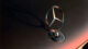 Close-up of a Mercedes-Benz emblem on a car hood, highlighting the iconic three-pointed star logo against a smooth, metallic surface.