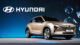 A Hyundai SUV is showcased on a stage with a large Hyundai logo backdrop, under bright lighting, emphasizing its sleek design.