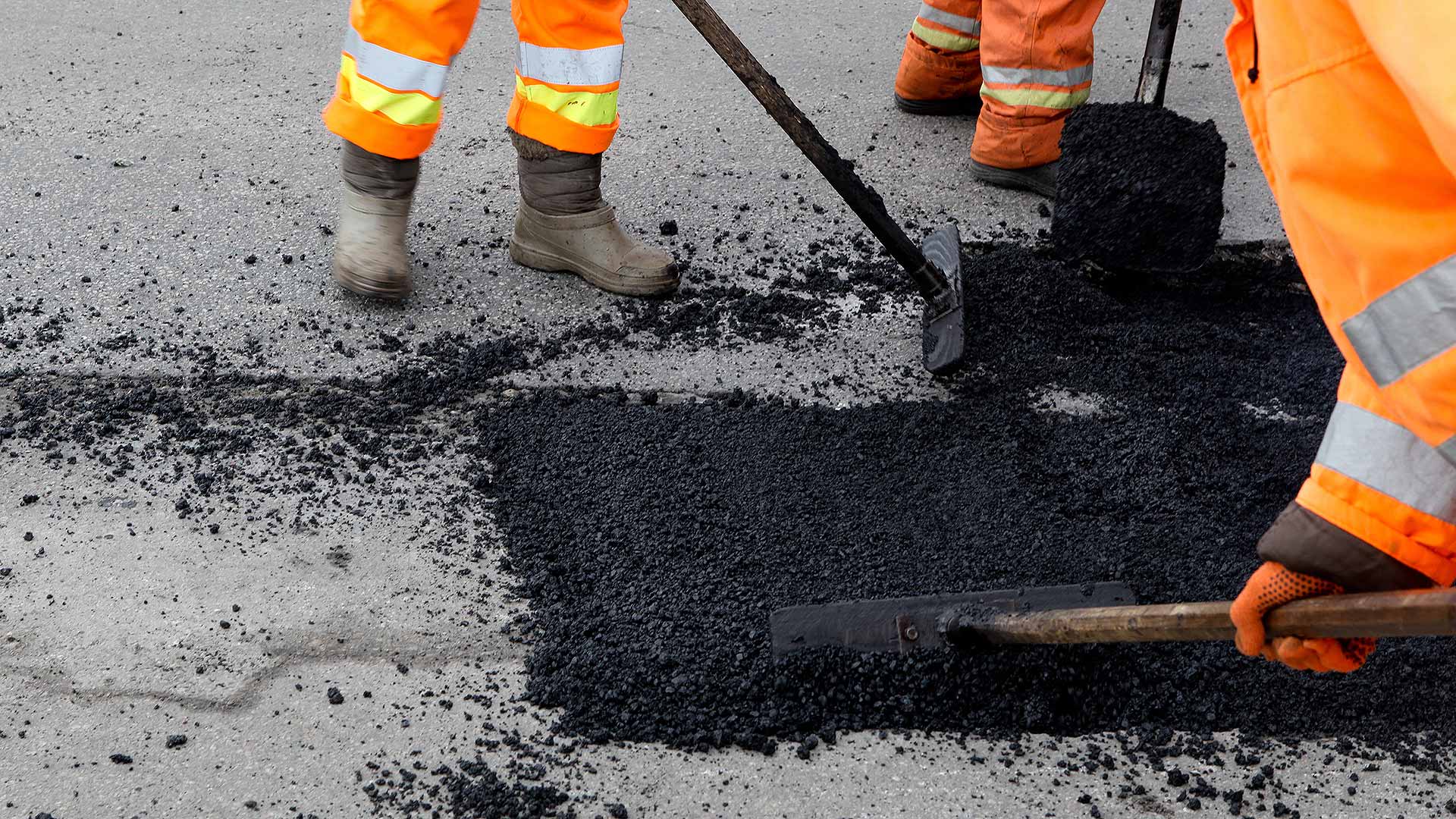 Road workers fixing a pothole