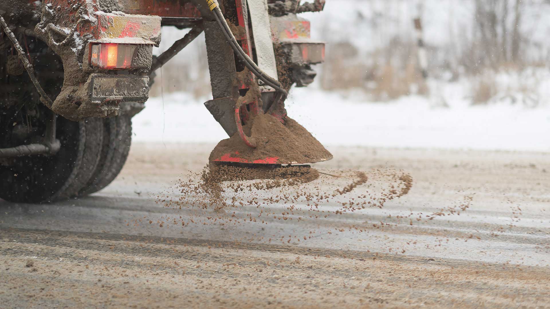 Close-up of a road gritter spreading salt