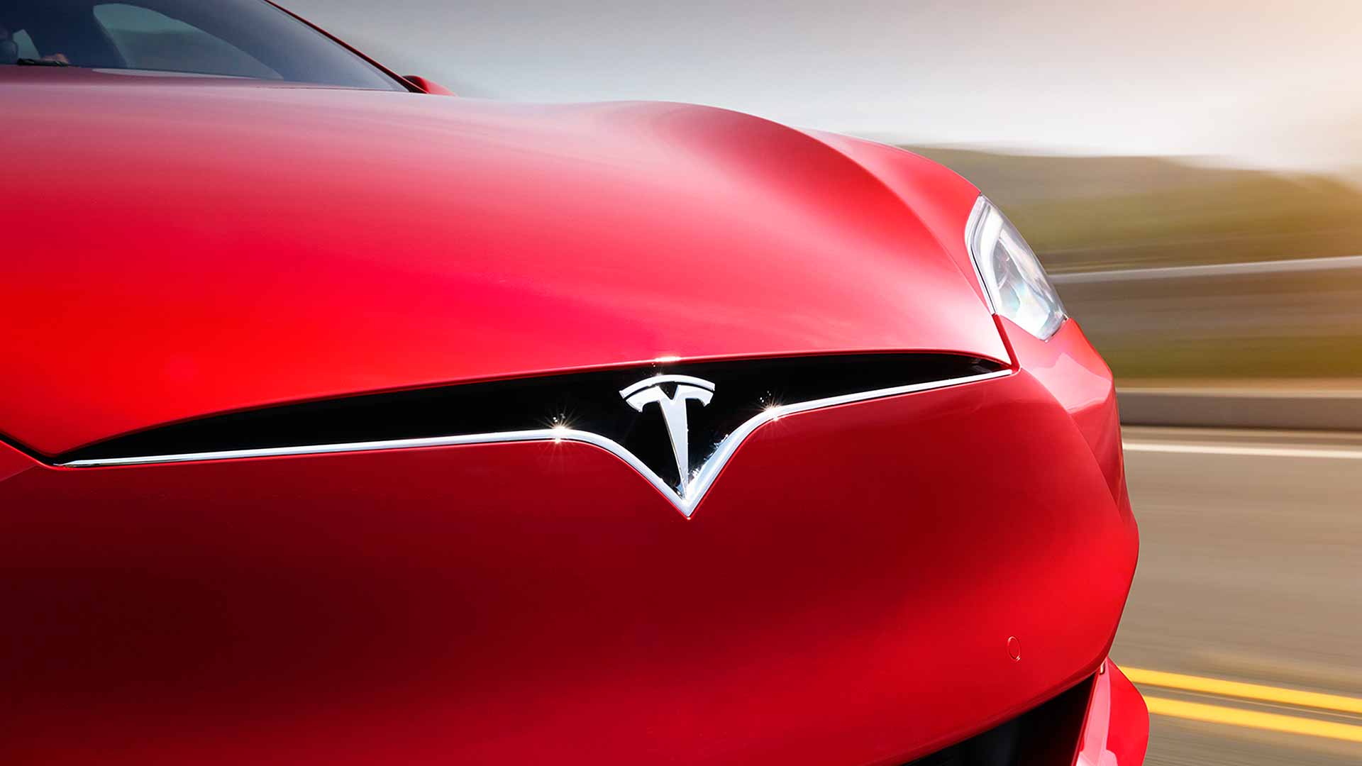 Tesla logo on a red Model S