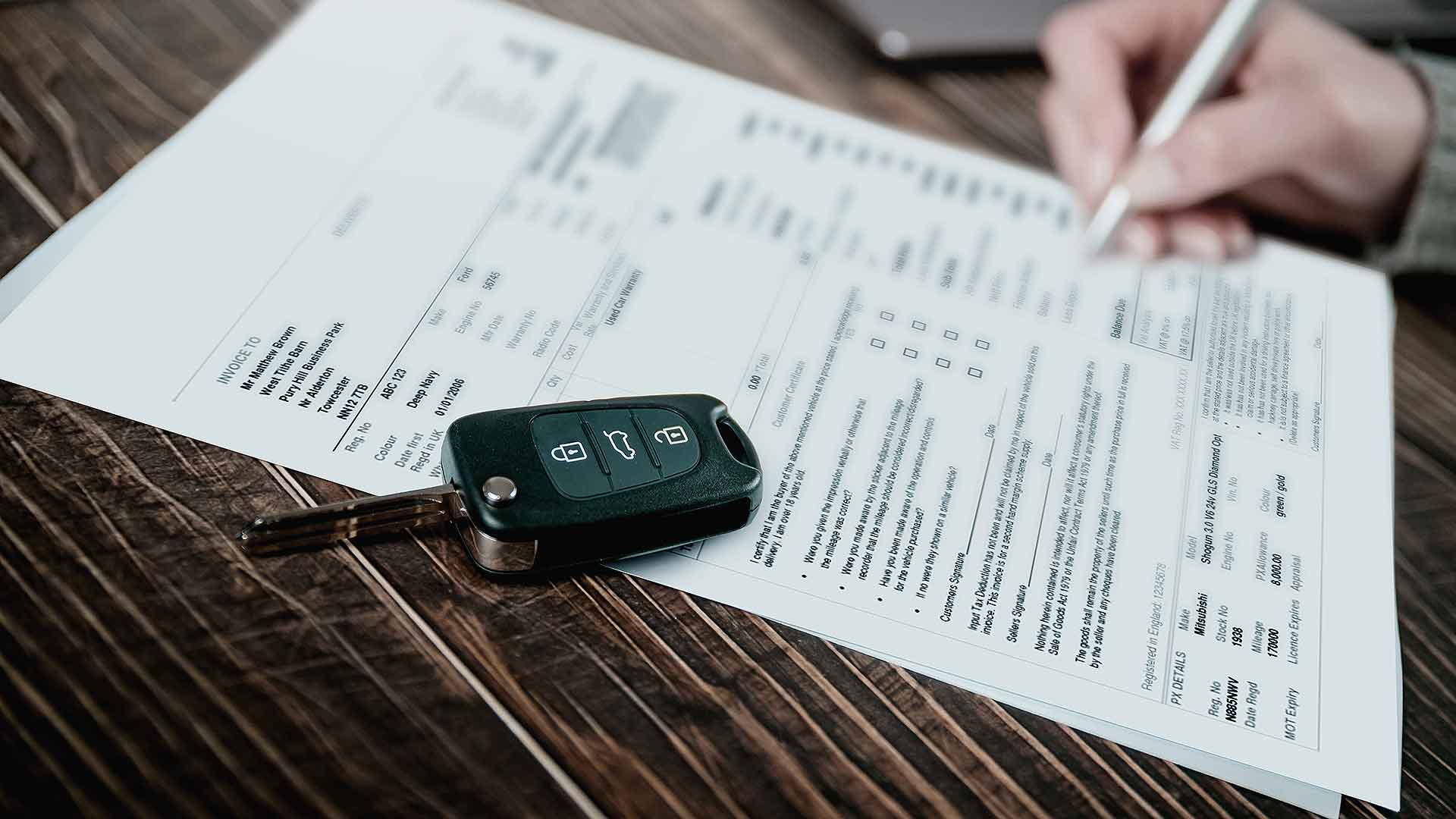 Customer signing a car finance loan agreement