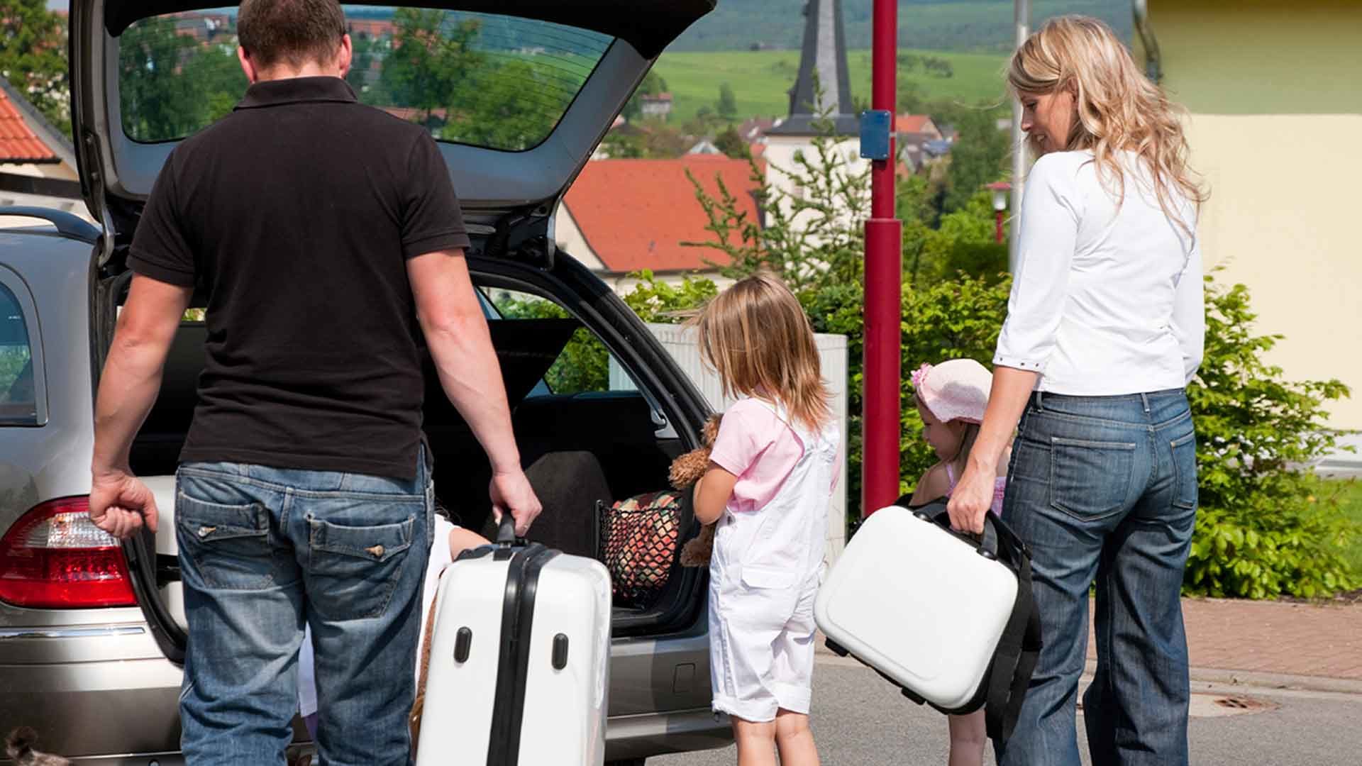 Family packing car for a summer holiday