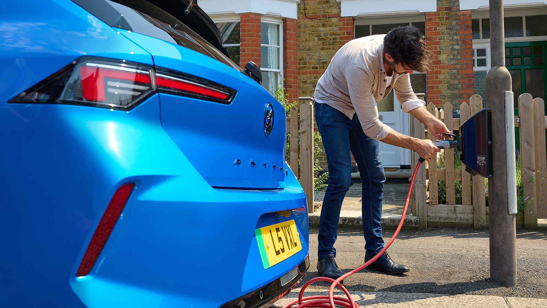 Man plugging in a new electric car